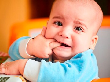 Baby holding fingers in mouth